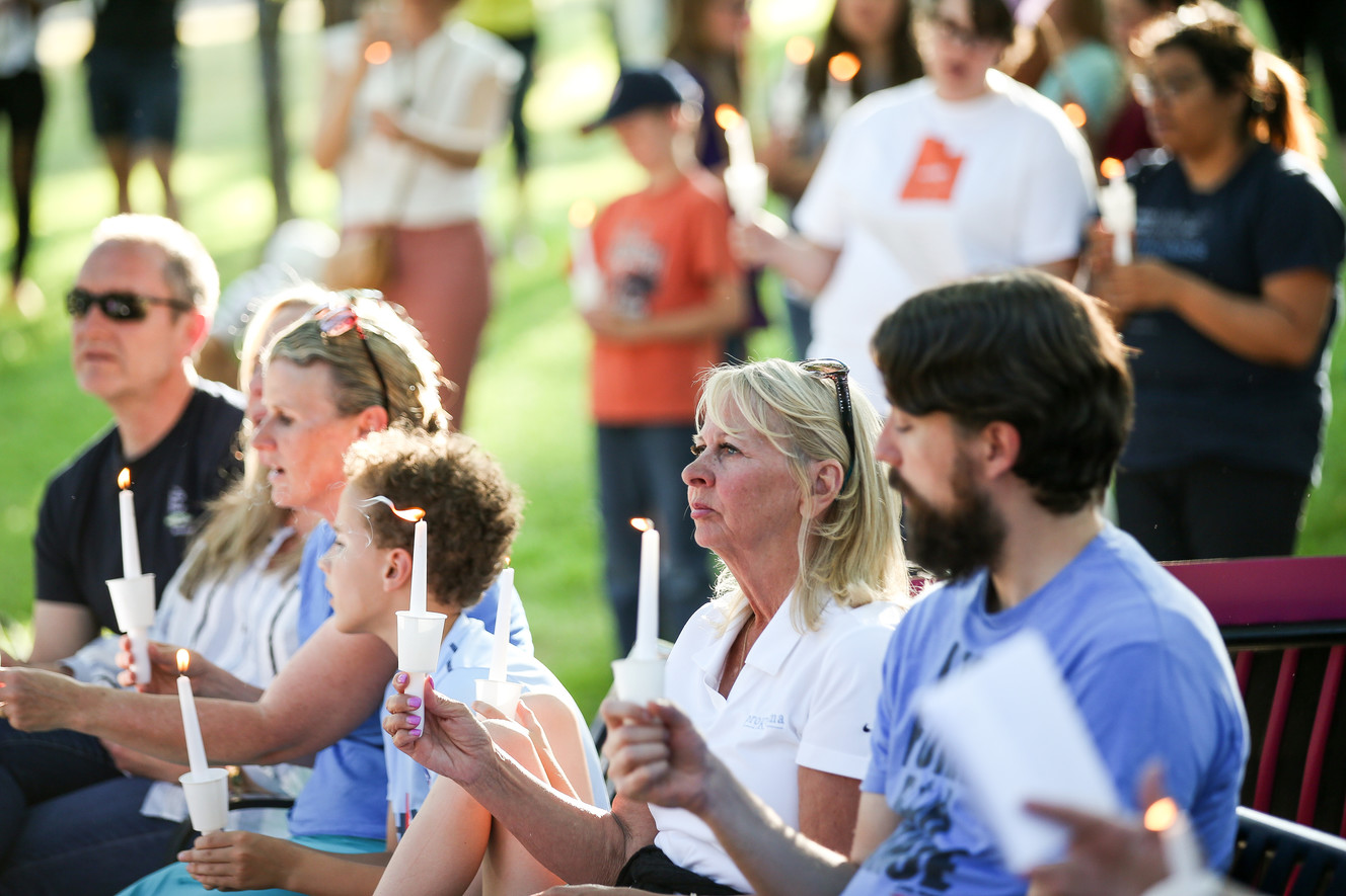 People hold candles and sing hymns at a "Keep Families Together Vigil" organized by Mormon Women for Ethical Government at City Creek Park in Salt Lake City on Saturday, June 23, 2018. (Photo: Spenser Heaps, KSL)