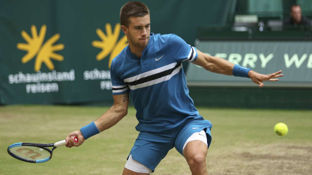 Coric ends Federer's winning streak to take Halle title