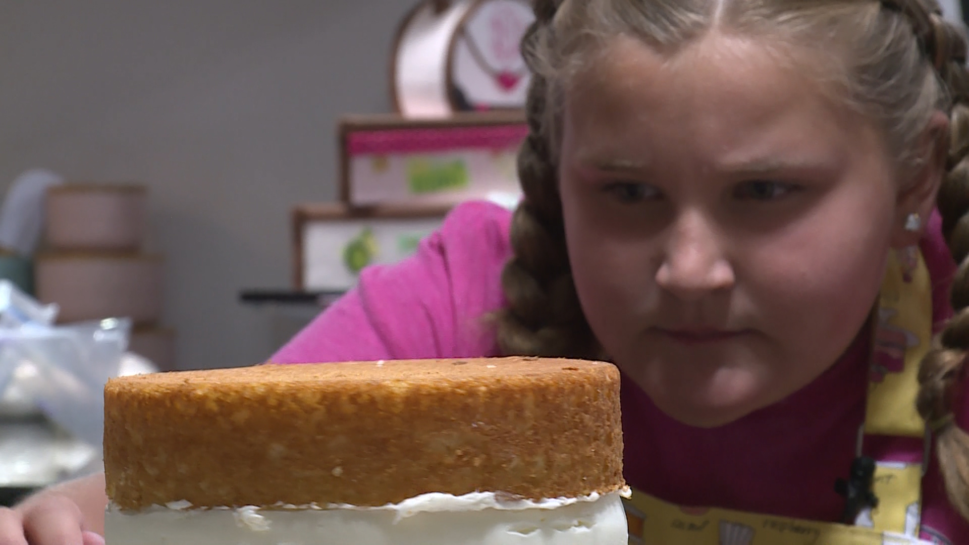 Addie Branham, 12, inspects a cake in progress in her basement kitchen in Lehi on Tuesday, June 19, 2018. (Photo: Ray Boone, KSL TV)