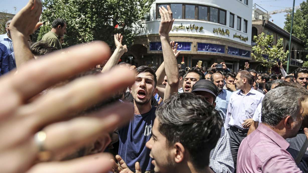 The Latest: Iranian protesters confront police in Tehran