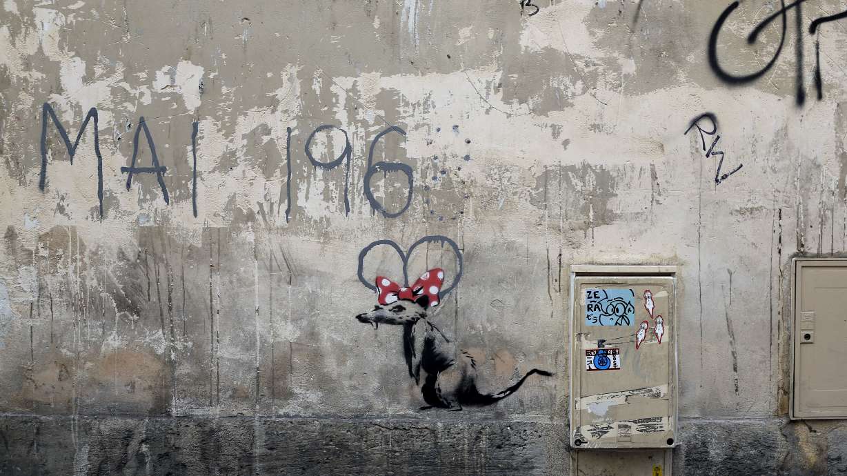 Street artist Banksy splashes Paris with works on migrants