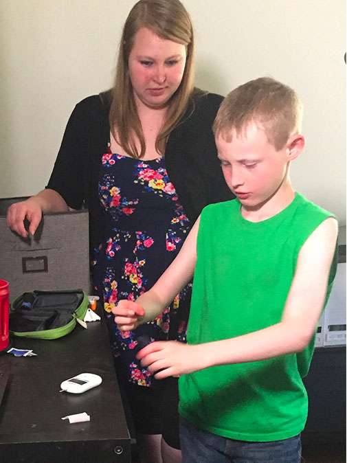 Devon Garrison, age 9, tests his blood to stay on top of his Type 1 Diabetes. His mother, Tristeena Williams, donates plasma twice a week to pay for his insulin. (Family photo)