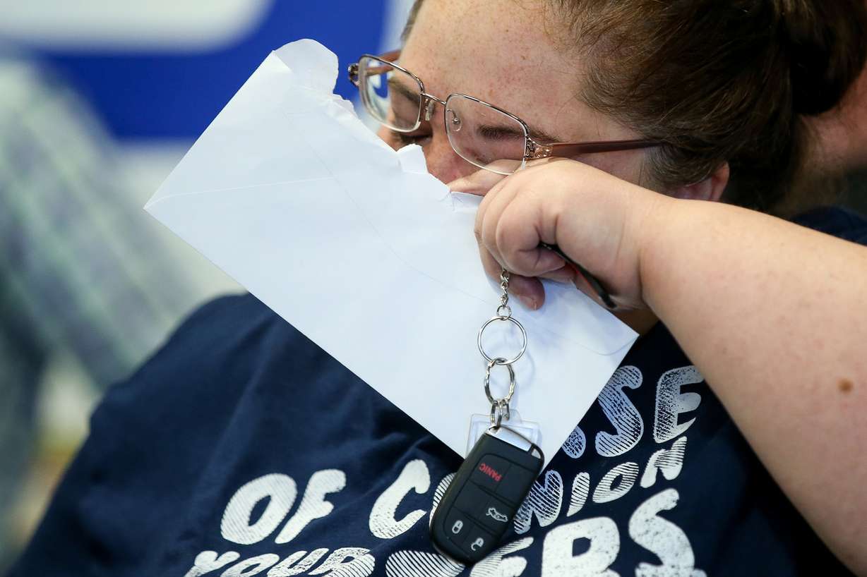 Darlene Lefevre wipes her eye while holding the key to a 2015 Chrysler 200 that was donated to her at Higgins Body and Paint in West Valley City on Wednesday, June 27, 2018. Geico and Higgins Body and Paint, along with other organizations, teamed up to donate a refurbished car to Lefevre and her daughter, who just moved out of a shelter and into an apartment a week ago. (Photo: Spenser Heaps, KSL)
