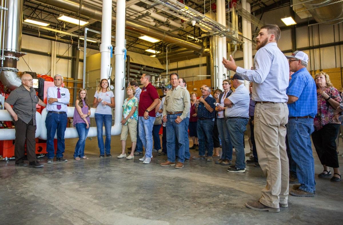 Southern Idaho Solid Waste Environmental Manager Nate Francisco, right, talks to people touring the new gas-to-energy facility Wednesday during the Flip The Switch opening event at the Milner Butte Landfill near Burley. (Photo: Pat Sutphin, Times-News)