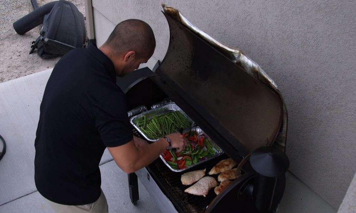 Josue Andrade, Tamara's husband, helps her meal prep by grilling chicken and veggies. (Photo: KSL TV)