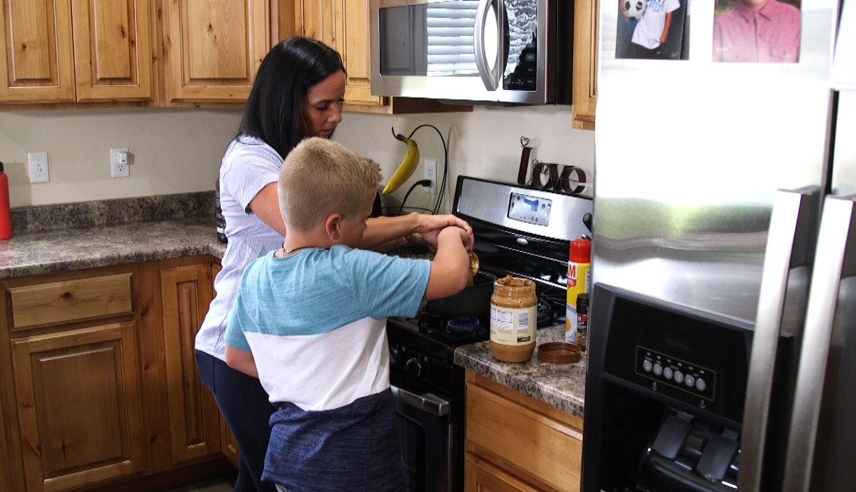 Tamara Andrade teachers her oldest son how to make protein balls while they meal prep. (Photo: KSL TV)