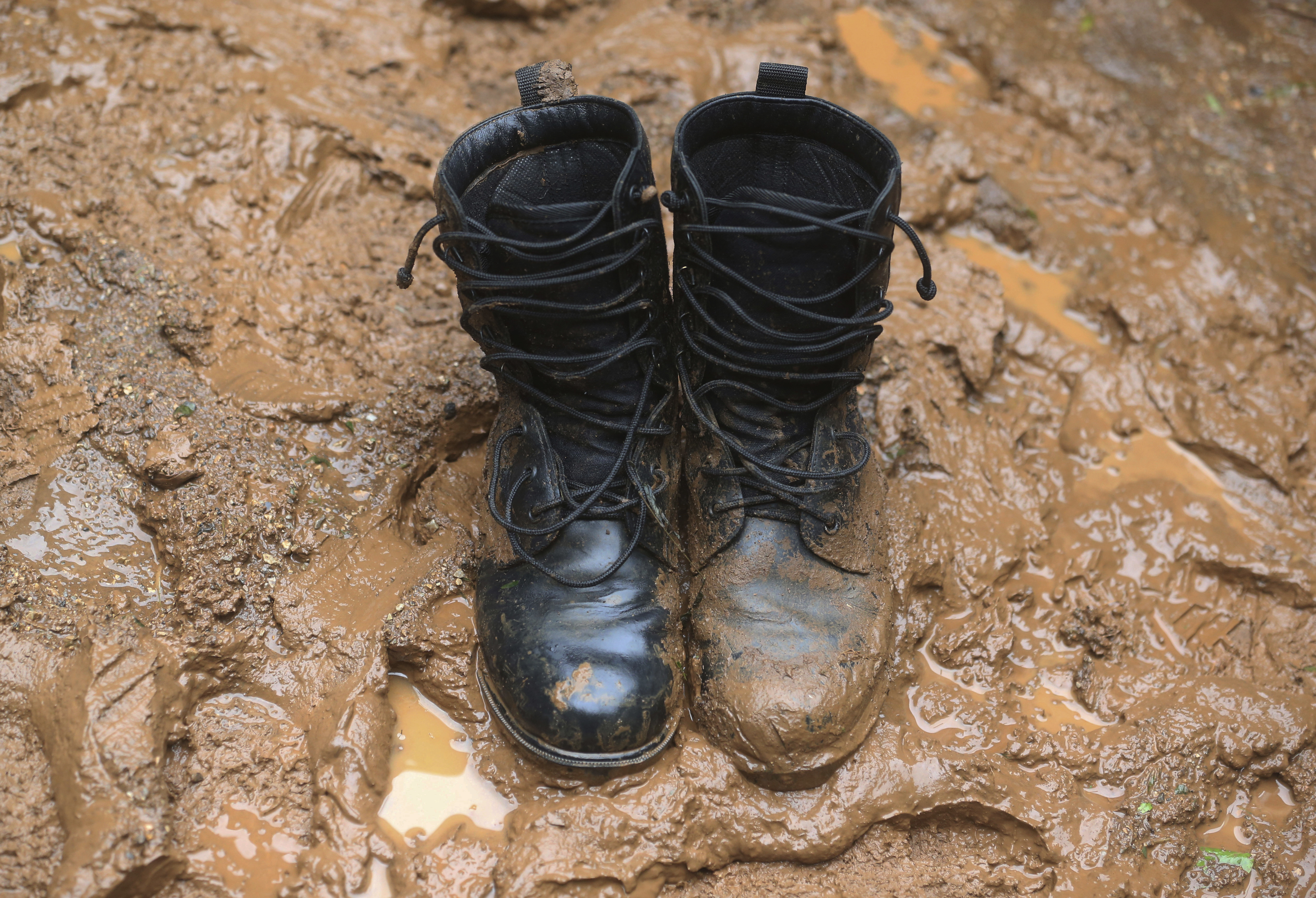 AP PHOTOS: Under pouring rain, Thai cave search a muddy slog