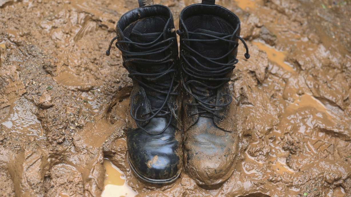 AP PHOTOS: Under pouring rain, Thai cave search a muddy slog