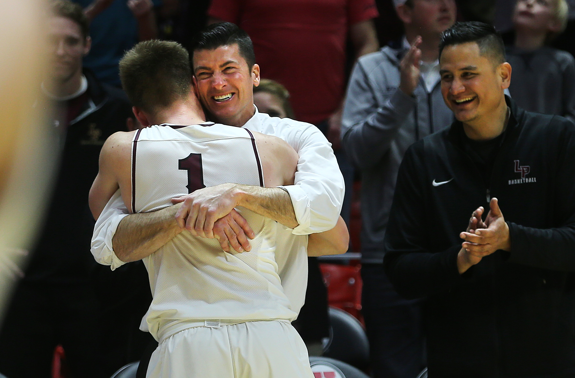 Lone Peak head coach David Evans hugs Max Brenchley as he comes out of the game as the Knights defeat Pleasant Grove in the 6A basketball championship in the Jon M. Huntsman Center at the University of Utah on Saturday, March 3, 2018. (Photo: Scott G Winterton, KSL)
