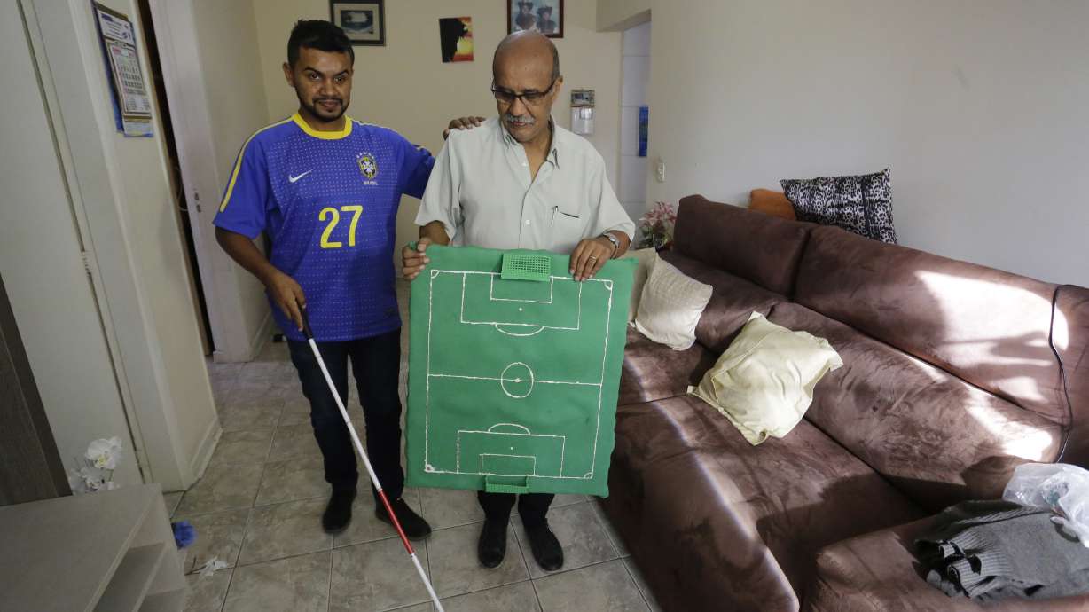 Brazil fan who is deaf, blind follows World Cup with help