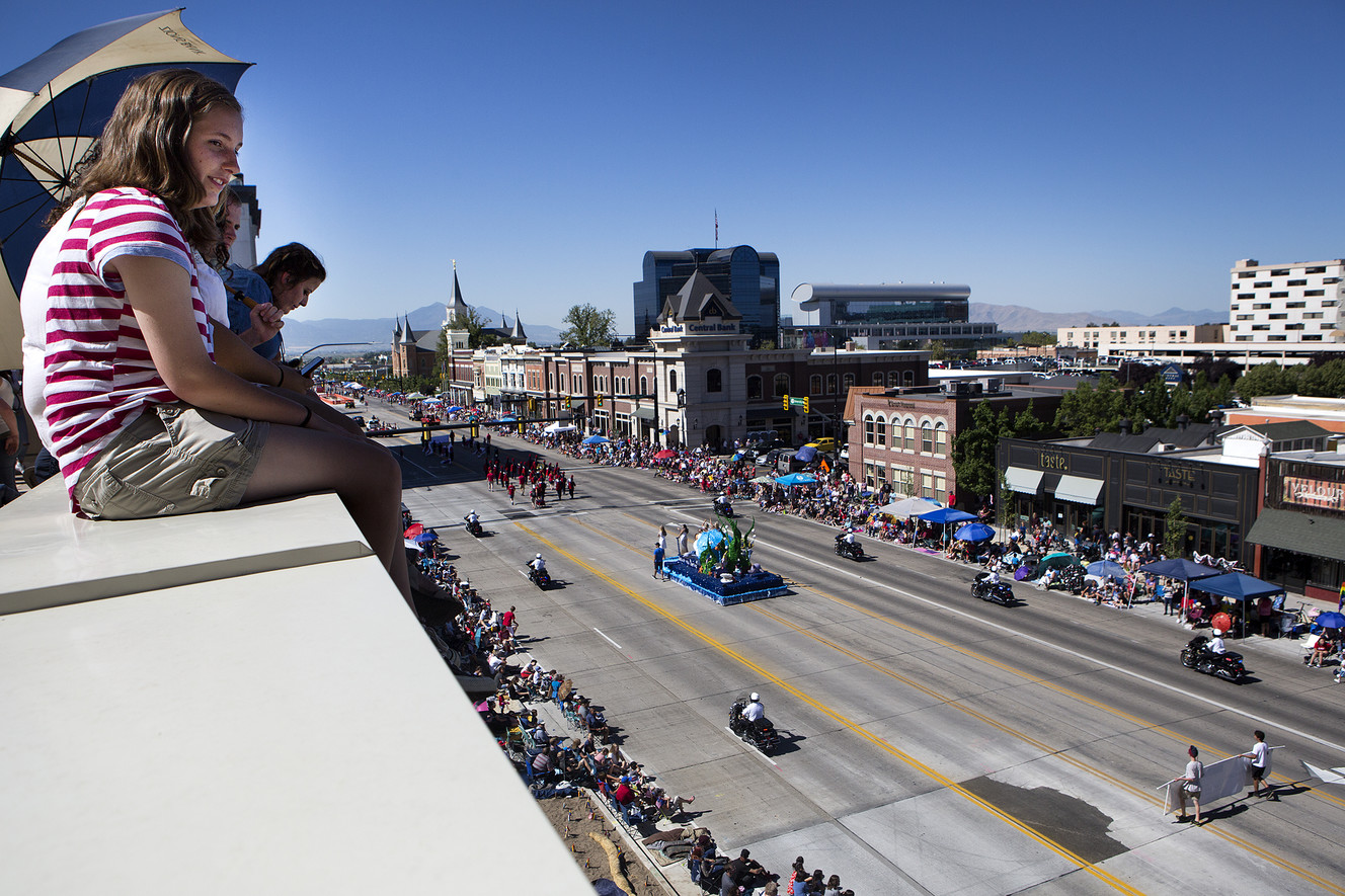 Emma Lopez, 17, watches the America's Freedom Festival Grand Parade from atop a wing of the Zions Bank Financial Center in Provo on Wednesday, July 4, 2018. (Photo: James Wooldridge, KSL)
