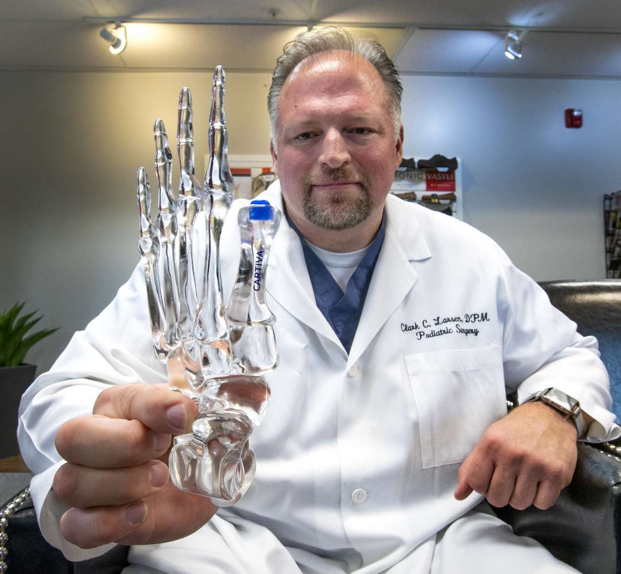 Dr. Clark Larsen, a podiatrist at Rocky Mountain Foot and Ankle in Murray, holds a model of a foot showing how the product Cartiva is implanted in the big toe joint, in his office on Friday, June 29, 2018. Cartiva is used to help patients with arthritis avoid having to fuse their big toe joint. (Photo: Steve Griffin, Deseret News)
