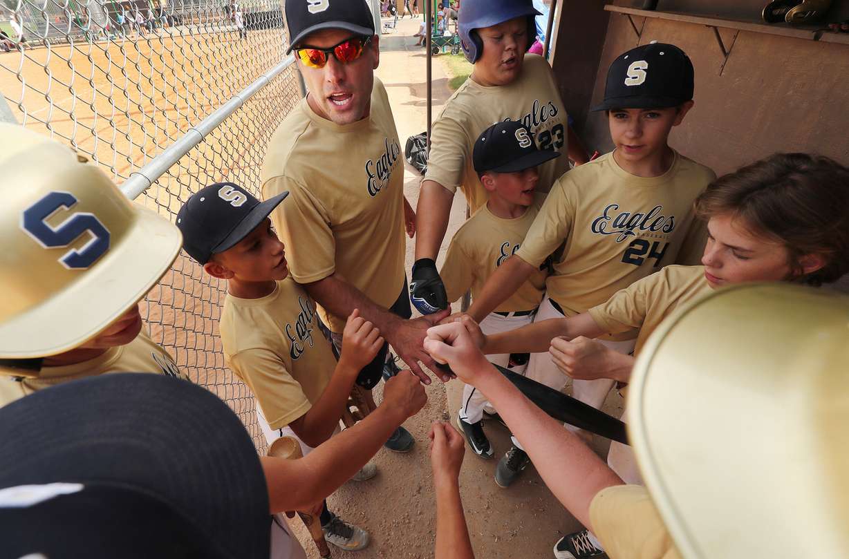 Ted Billick leads a cheer as he coaches a Little League Baseball game in Orem on Friday, June 29, 2018. Billick is an Utah amateur baseball league player who had Cartiva inserted in his big toe joint to avoid fusion so he can keep playing baseball. (Photo: Jeffrey D. Allred, Deseret News)