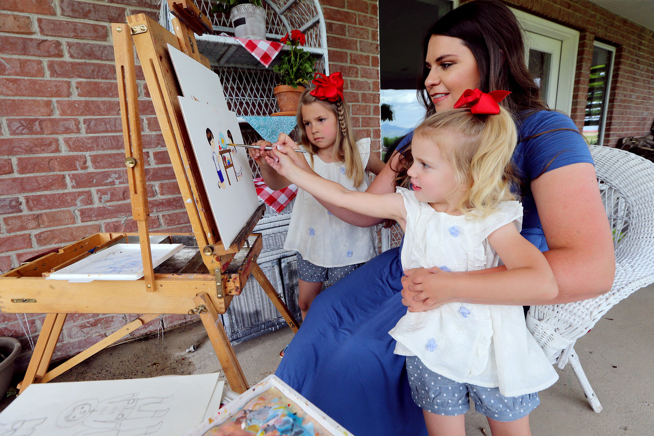 Amelia Murdock, who has created a series of phonics books and has started selling them online, paints with daughters Lydia and Vivian at their West Mountain home near Payson on Monday, May 21, 2018. (Photo: Scott G Winterton, Deseret News)