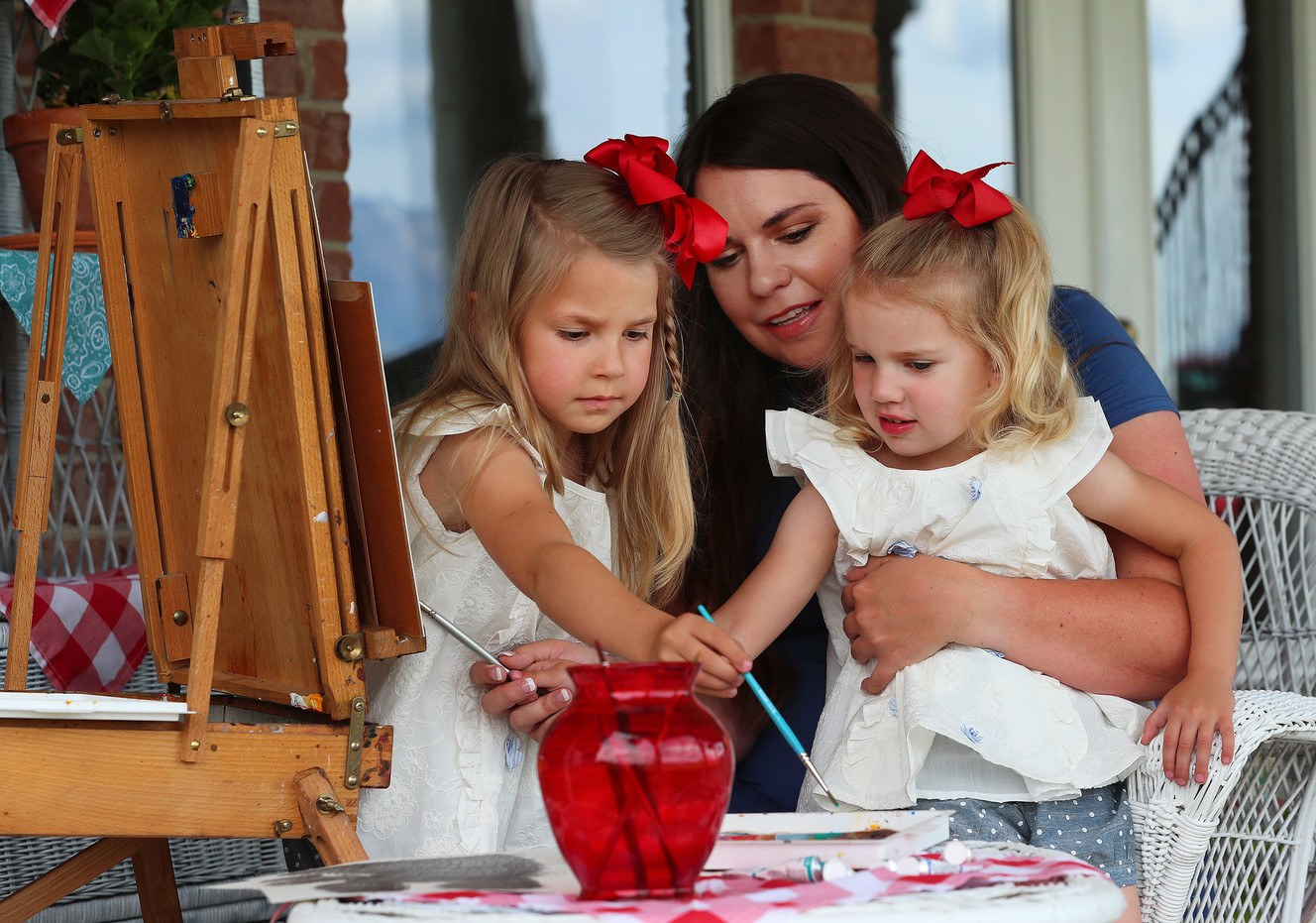 Amelia Murdock, who has created a series of phonics books and has started selling them online, paints with daughters Vivian, and Lydia at their West Mountain home near Payson on Monday, May 21, 2018. (Photo: Scott G Winterton, Deseret News)