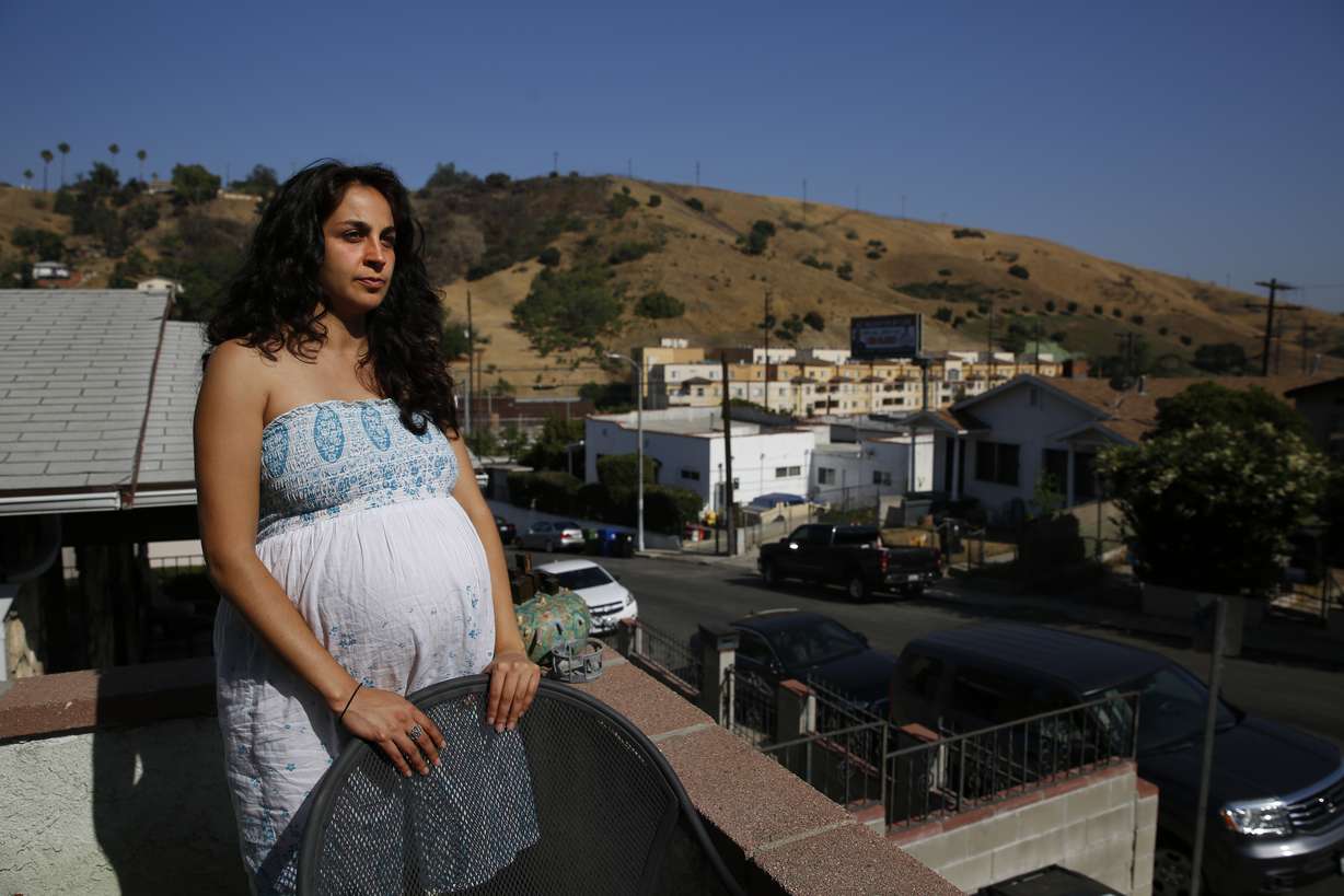 In this Wednesday, June 20, 2018, photo, Mariella Saba pauses for photos in the patio of her home in the Rose Hill neighborhood of Los Angeles. Saba, who who helped co-found Stop LAPD Spying Coalition suspects police are paying special attention to her Los Angeles neighborhood because of a computer algorithm. (Jae C. Hong, AP Photo)