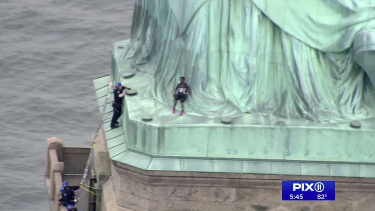 The Latest: Trump calls Statue of Liberty climber a clown