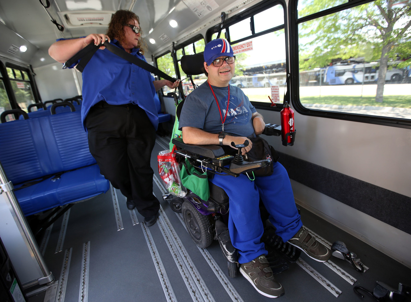 Dana Hosking straps in Jerry Lambertus on a UTA paratransit vehicle after an open house celebrating the 30-year anniversary of paratransit's inception within the agency at the Riverside/Paratransit headquarters in South Salt Lake on Thursday, July 5, 2018. (Photo: Kristin Murphy, KSL)