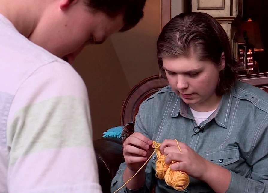 Connor Munden, an Eagle Scout candidate from Highland, works on unknotting yarn for the Magic Yarn Project. (Photo: KSL TV)