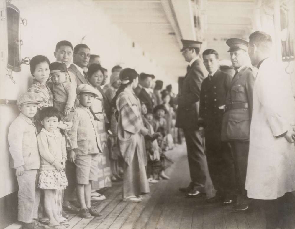 Immigration officials examining Japanese passengers aboard the ship Shimyo Maru, at Angel Island 1931. Immigration Act of 1924 severely restricted Japanese immigration to the U.S. (Photo: Everett Historical Photos, Shutterstock)