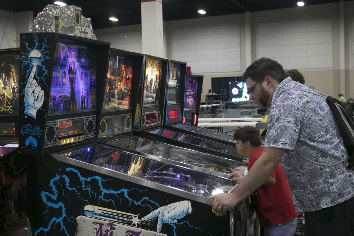People play on machines in the pinball display Friday, July 6, 2018, at the Salt Lake Gaming Con in Sandy. The event started Friday and continues through midnight Saturday at the Mountain America Expo Center. (Photo: Jacob Klopfenstein, KSL.com)