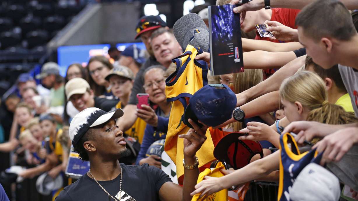 Utah Jazz's Donovan Mitchell signs autographs following the team's NBA summer league basketball game against the Atlanta Hawks on Thursday, July 5, 2018, in Salt Lake City. (AP Photo/Rick Bowmer)