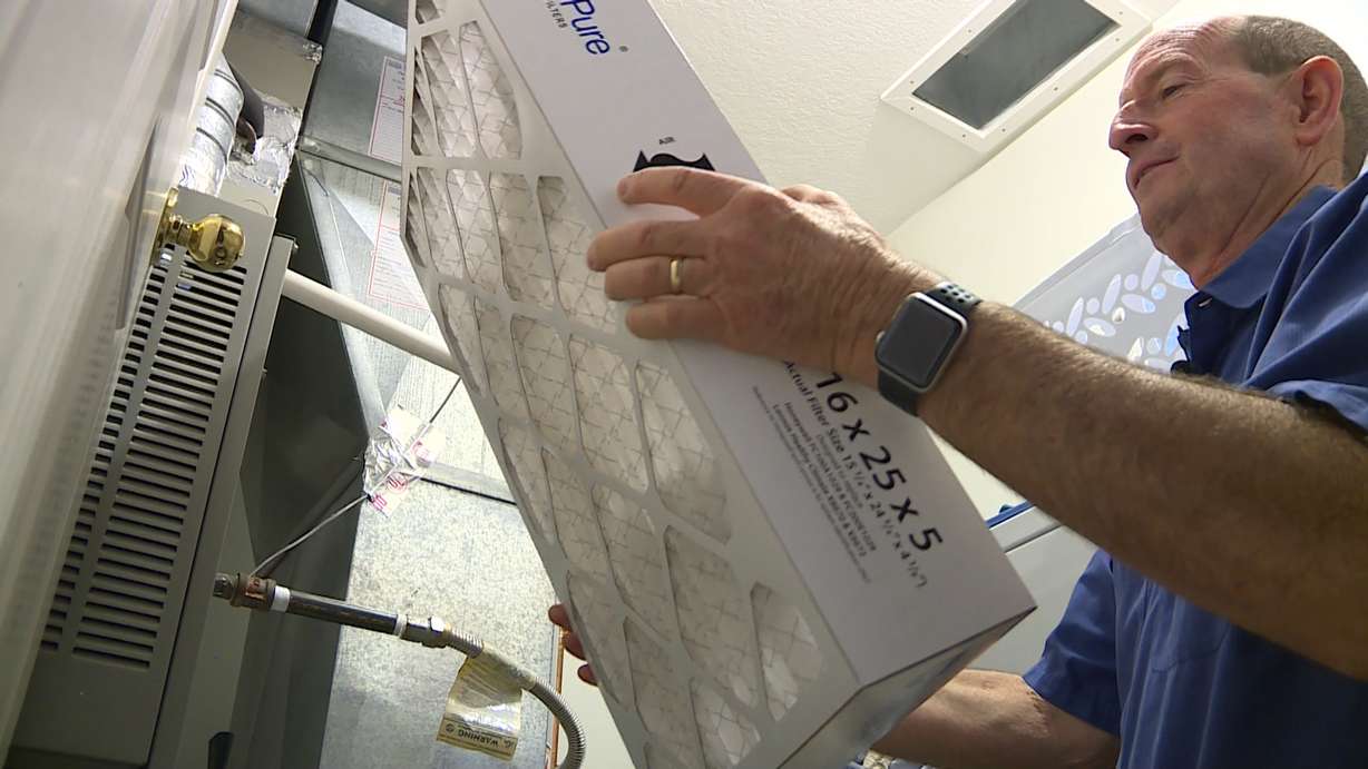HVAC specialist Dan Dearden checks an air filter. Photo: KSL TV