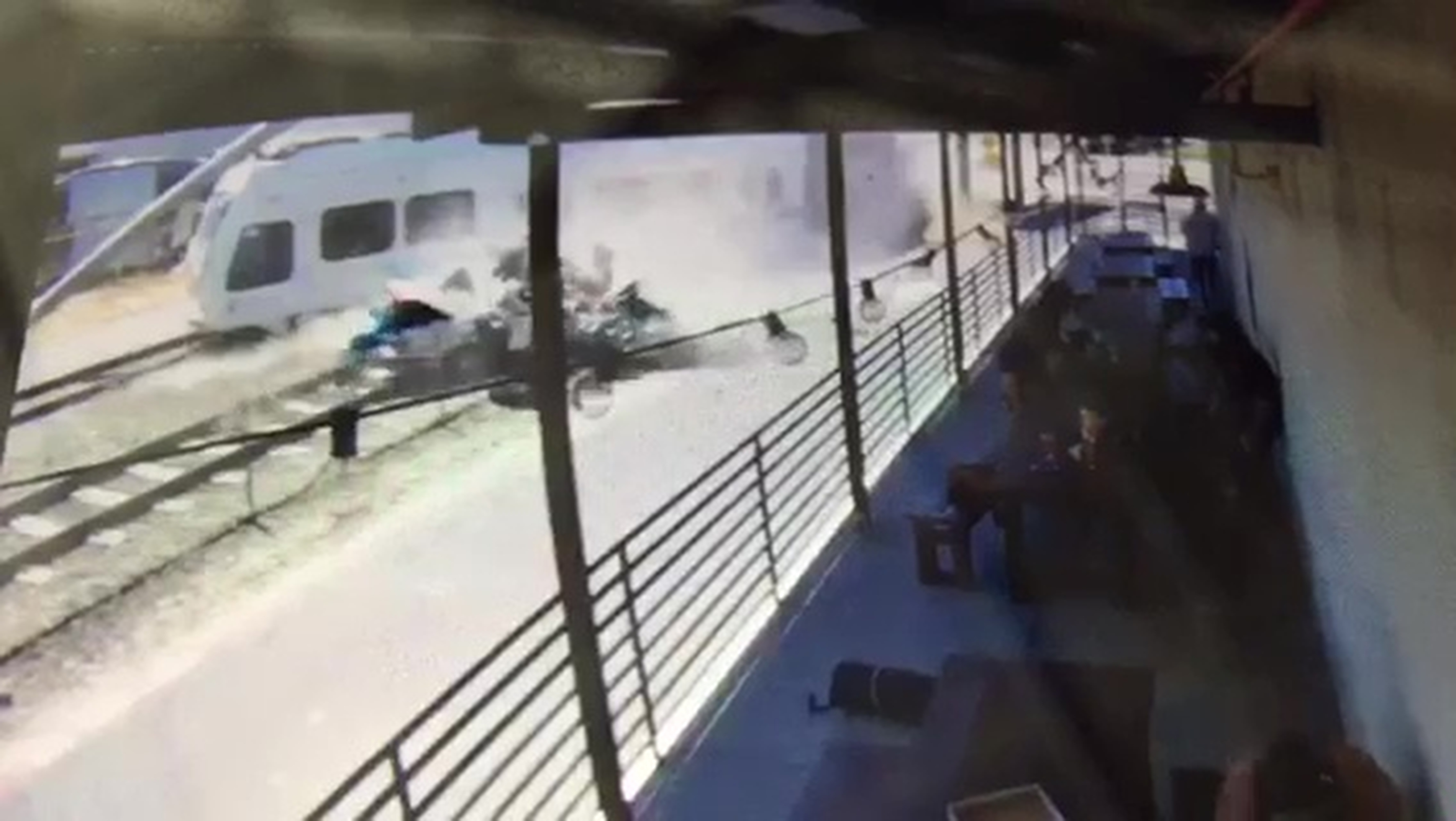 Video shows train hitting, pushing car near patio; 2 killed