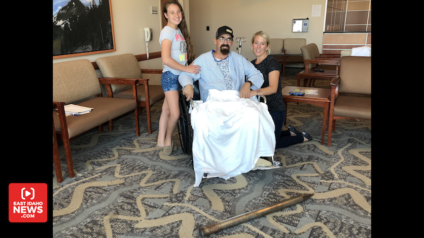 Justin and Anny Firth pose with their daughter and the spear that impaled him. (Photo: Nate Eaton, EastIdahoNews.com)