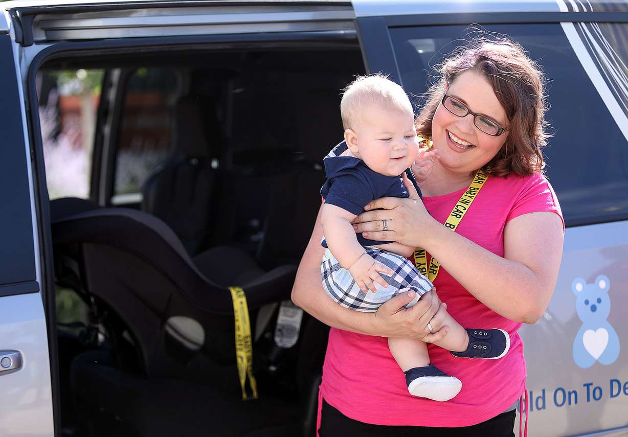 Felicia Ellis holds her baby, Sawyer Ellis, during a press conference about Baby Safety Snaps, a safety device that helps prevent heat-related child injuries and deaths inside vehicles, outside Primary Children’s Hospital Outpatient Services Building in Salt Lake City on Tuesday, July 10, 2018. (Photo: Kristin Murphy, KSL)