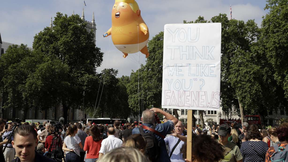 AP PHOTOS: Humor, irreverence in UK anti-Trump signs