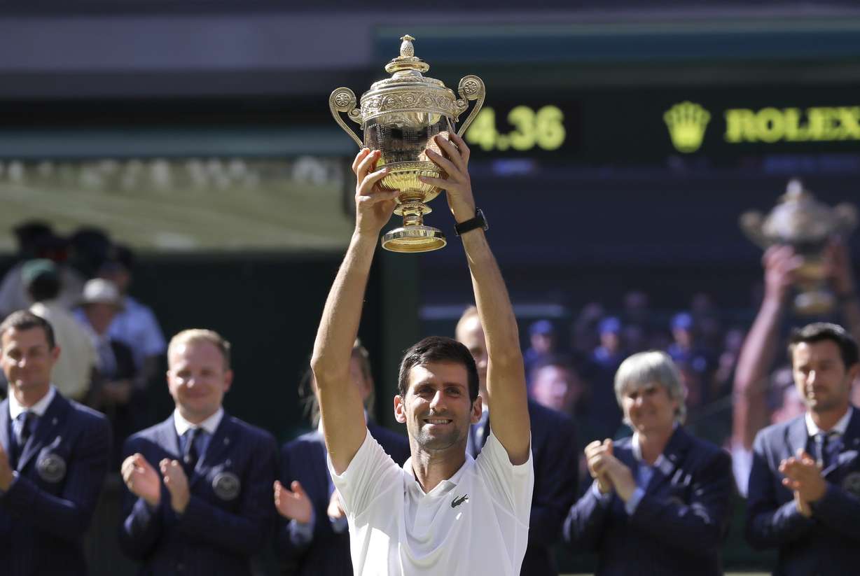 Serbia's Novak Djokovic lifts the trophy after winning the men's singles final match against Kevin Anderson of South Africa, at the Wimbledon Tennis Championships, in London, Sunday July 15, 2018.(Photo: Kirsty Wigglesworth, AP)