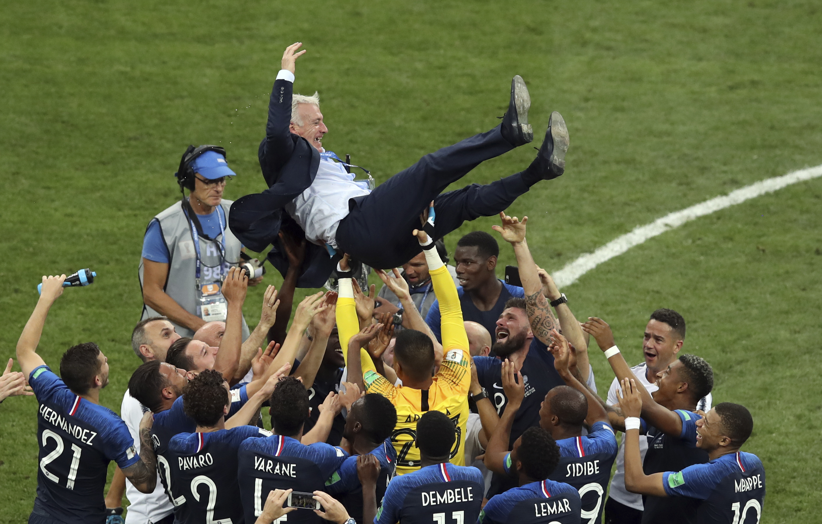 French players throw France head coach Didier Deschamps into the air celebrating at the end of the final match between France and Croatia at the 2018 soccer World Cup in the Luzhniki Stadium in Moscow, Russia, Sunday, July 15, 2018. (AP Photo)