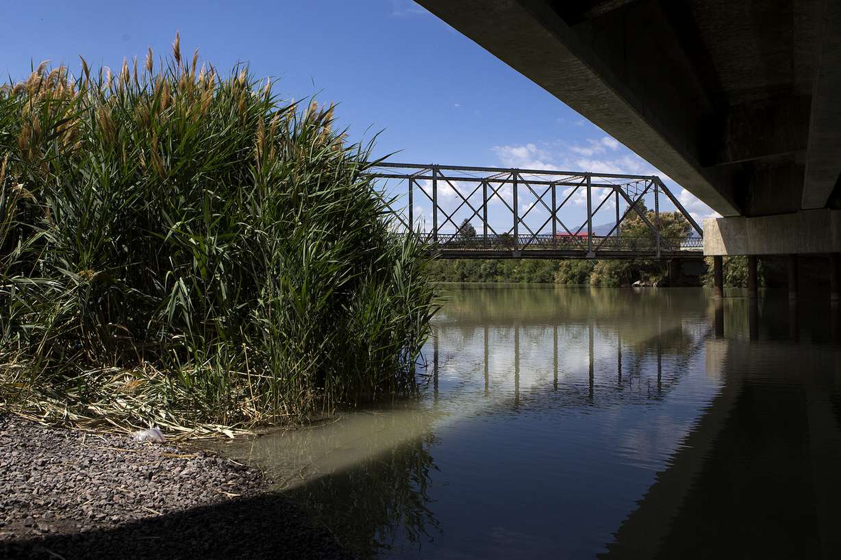 A century-old bridge crosses the Jordan River, pictured from under a newer bridge, in Lehi on Friday, July 13, 2018. City officials are considering demolishing the old bridge after a teenager died jumping from it on July 7. (Photo: James Wooldridge, KSL)