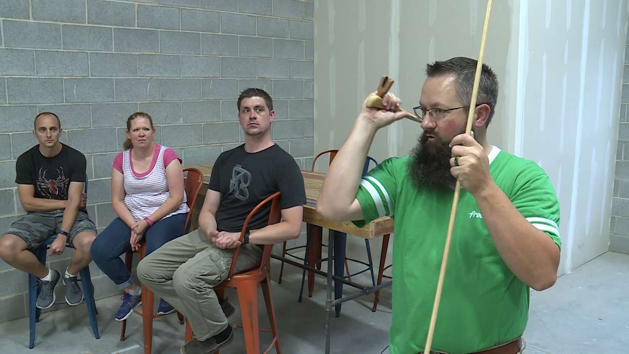 Taylor Reynolds, far right, shows the proper way to use an atlatl on Tuesday, July 3rd, 2018. (Photo: Ray Boone, KSL TV)