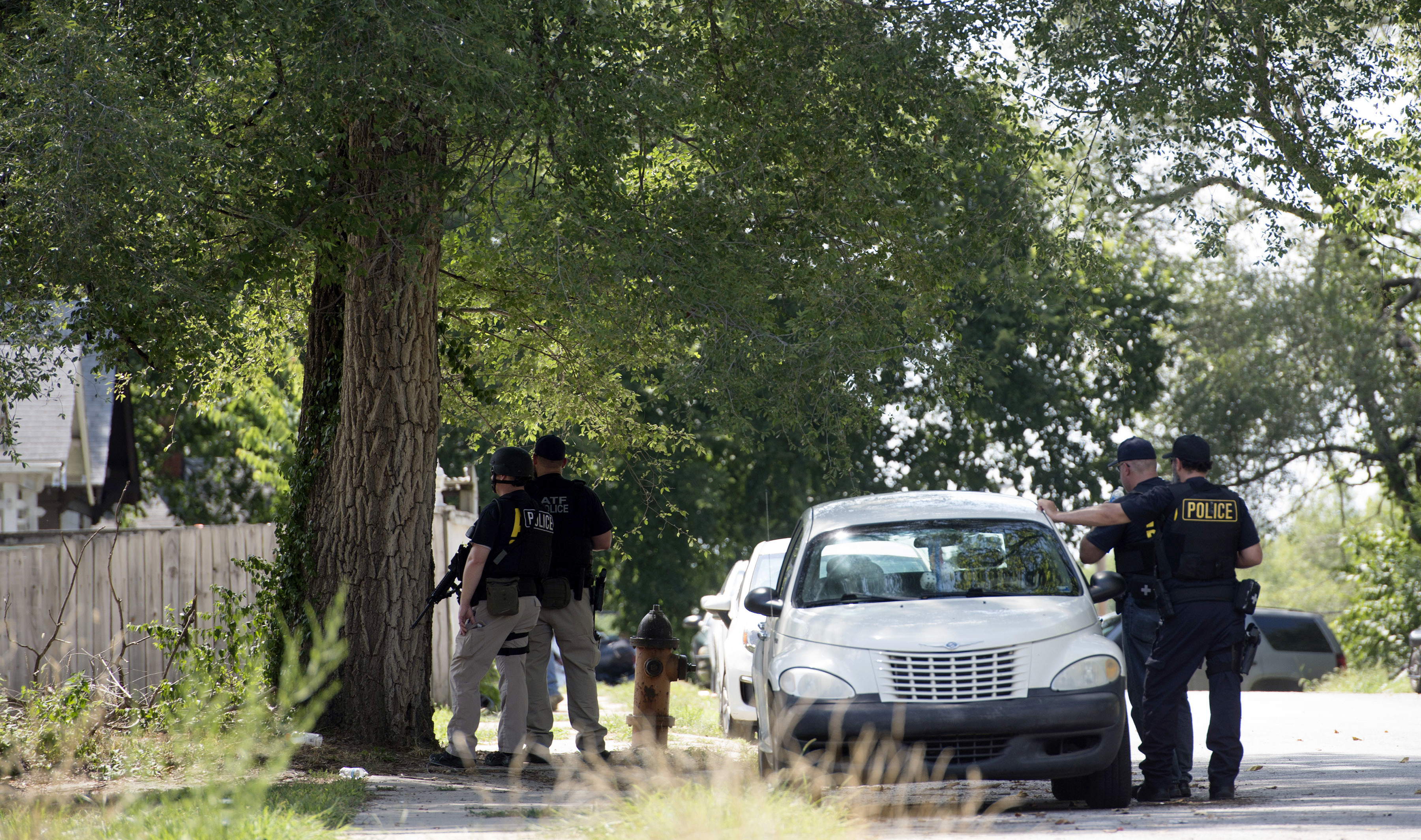 The Latest: Suspect identified in officers' shooting