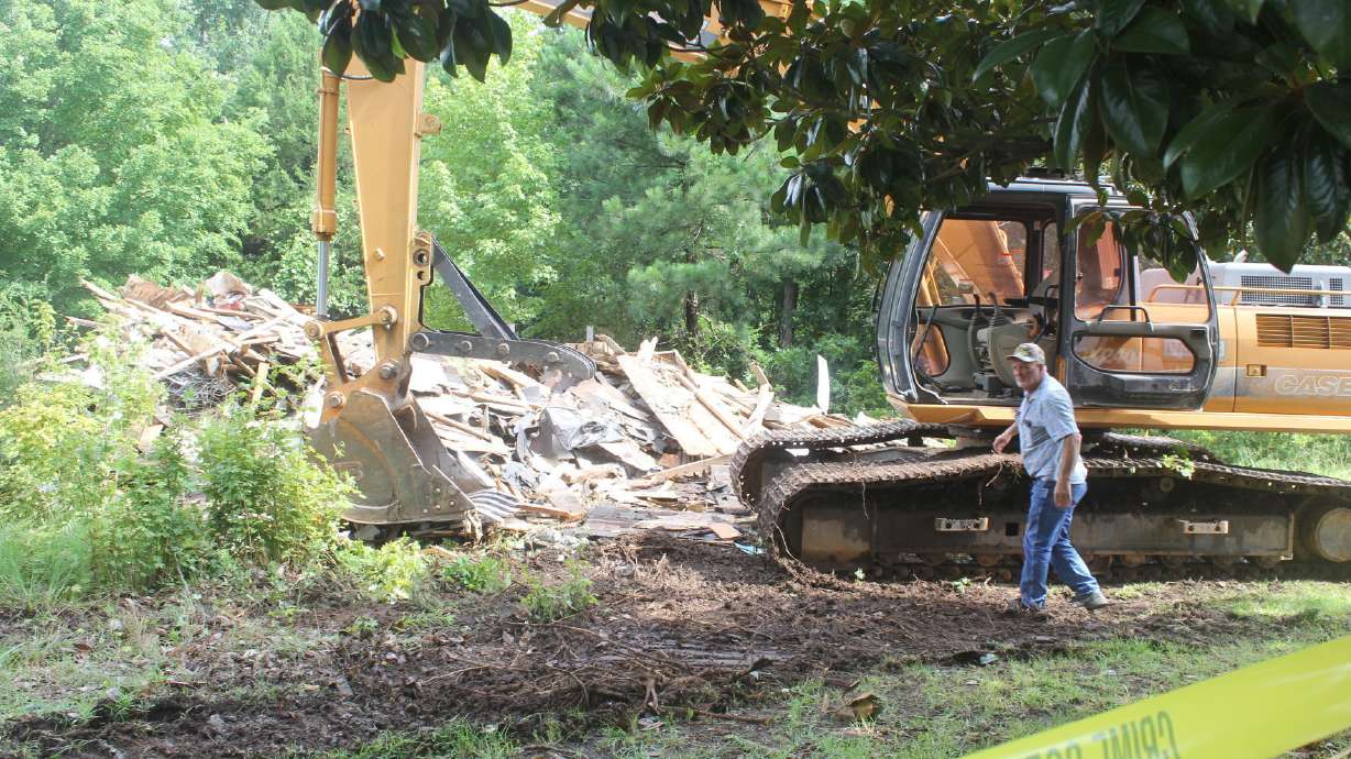 Backhoe demolishes home where 2 officers were killed in 2003