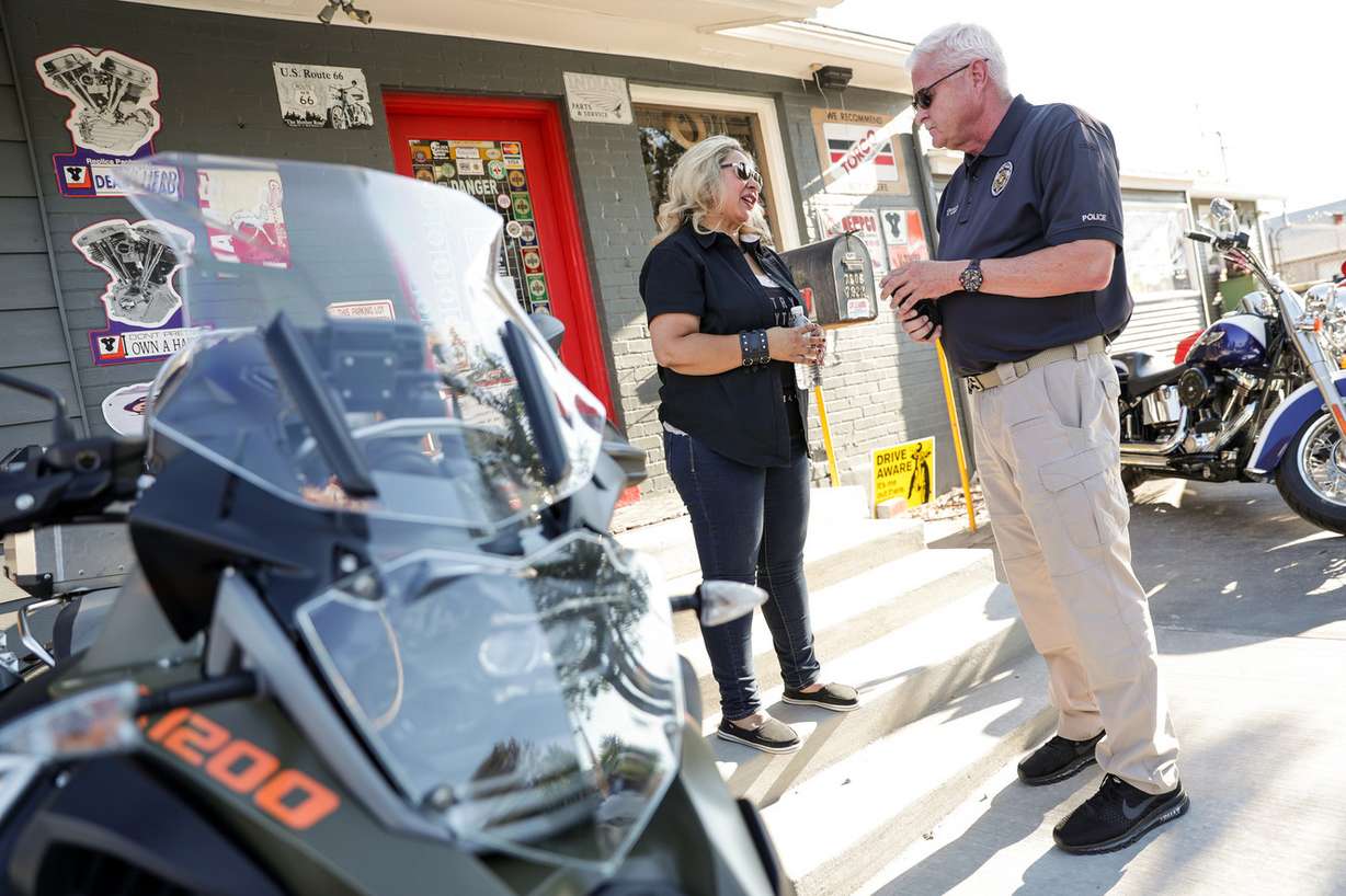 Elvecia Ramos, founder of The Riderz Association, talks to Unified police detective Ken Hansen before a meeting about motorcycle safety hosted by the Riderz Foundation at Caesar's Motorcycle Empire in Midvale on Wednesday, July 18, 2018. (Photo: Spenser Heaps, KSL)