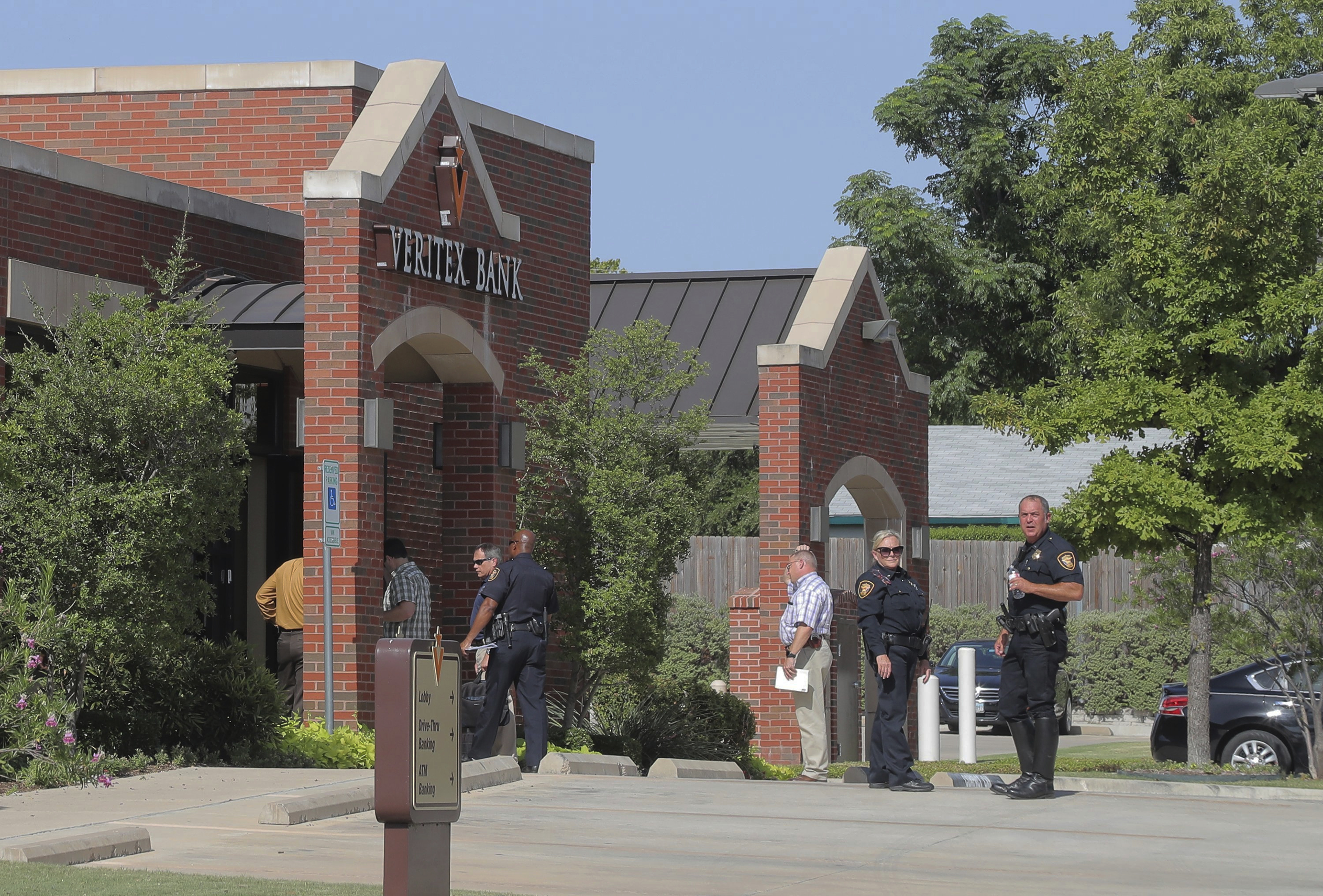 The Latest: Police: 3 detained in bank robbery shooting
