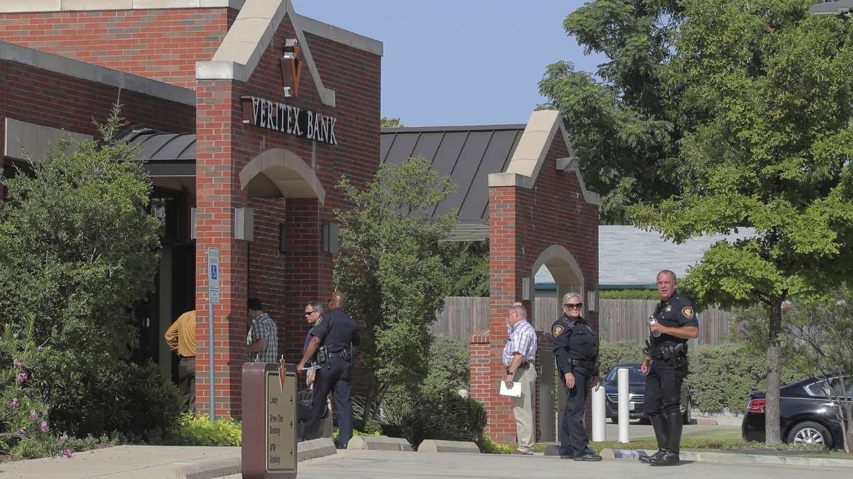 The Latest: Police: 3 detained in bank robbery shooting