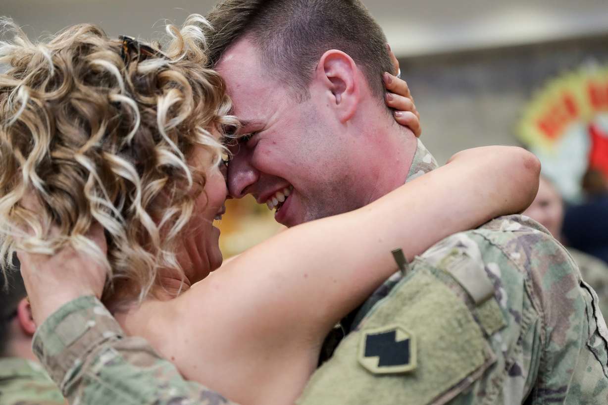 Lauren Hood embraces her boyfriend, Sgt. Jordan Lampe, at the Salt Lake City International Airport on Thursday, July 19, 2018. Twelve Utahns serving in the U.S. Army Reserve's 478th Human Resources Company's returned home after a nine-month deployment to the Middle East. (Photo: Spenser Heaps, KSL)