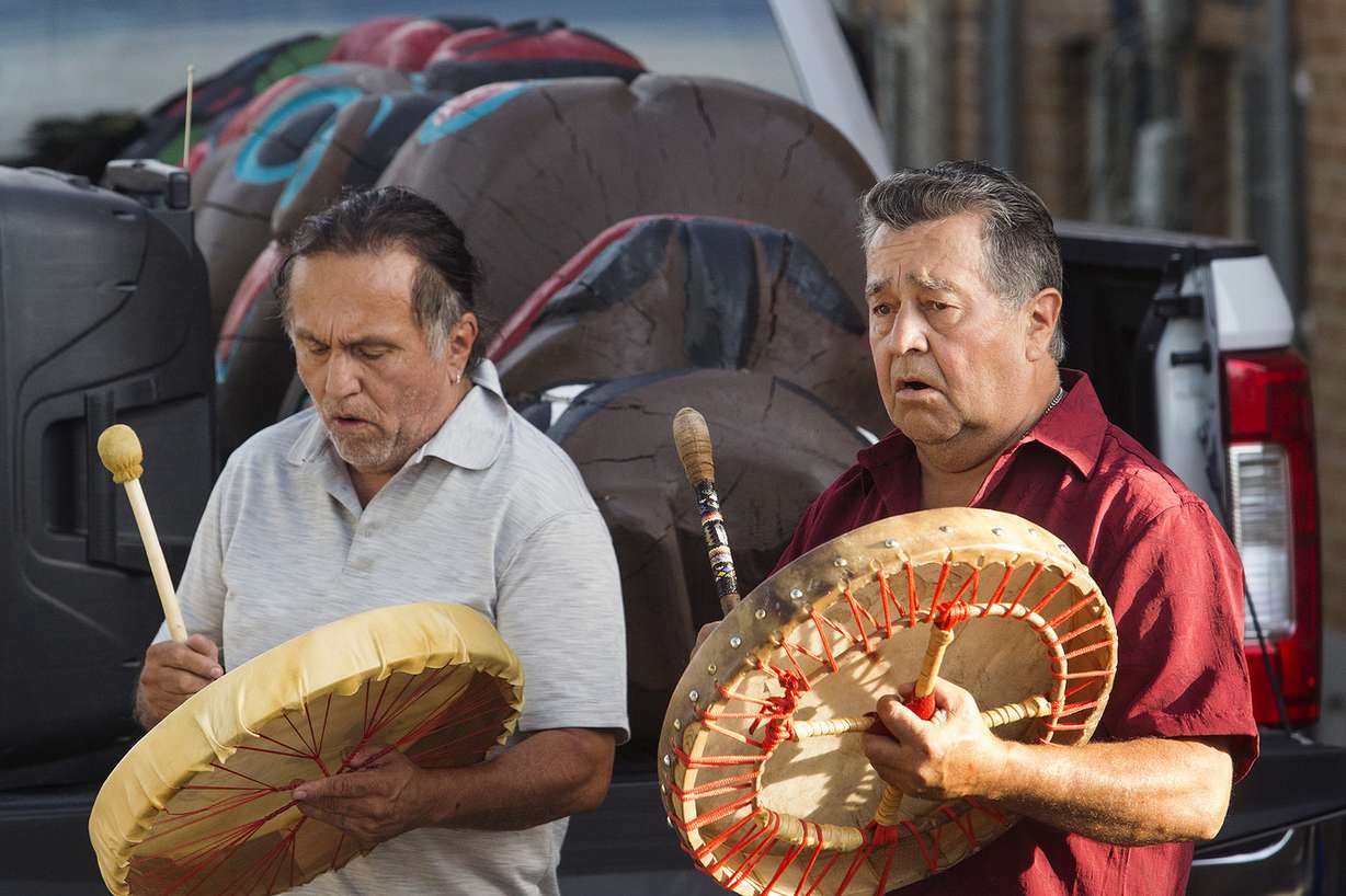 Jewell James, left, and Douglass James sing a song at the Urban Indian Center in Salt Lake City on Thursday, July 19, 2018. The Lummi Nation is gifting a 9-foot tall bear totem, seen resting in the back of the pickup truck, to the Bear Ears Inter-Tribal Coalition to show support for the restoration of Bear Ears National Monument. It is believed to bless those who touch it. (Photo: James Wooldridge, KSL)