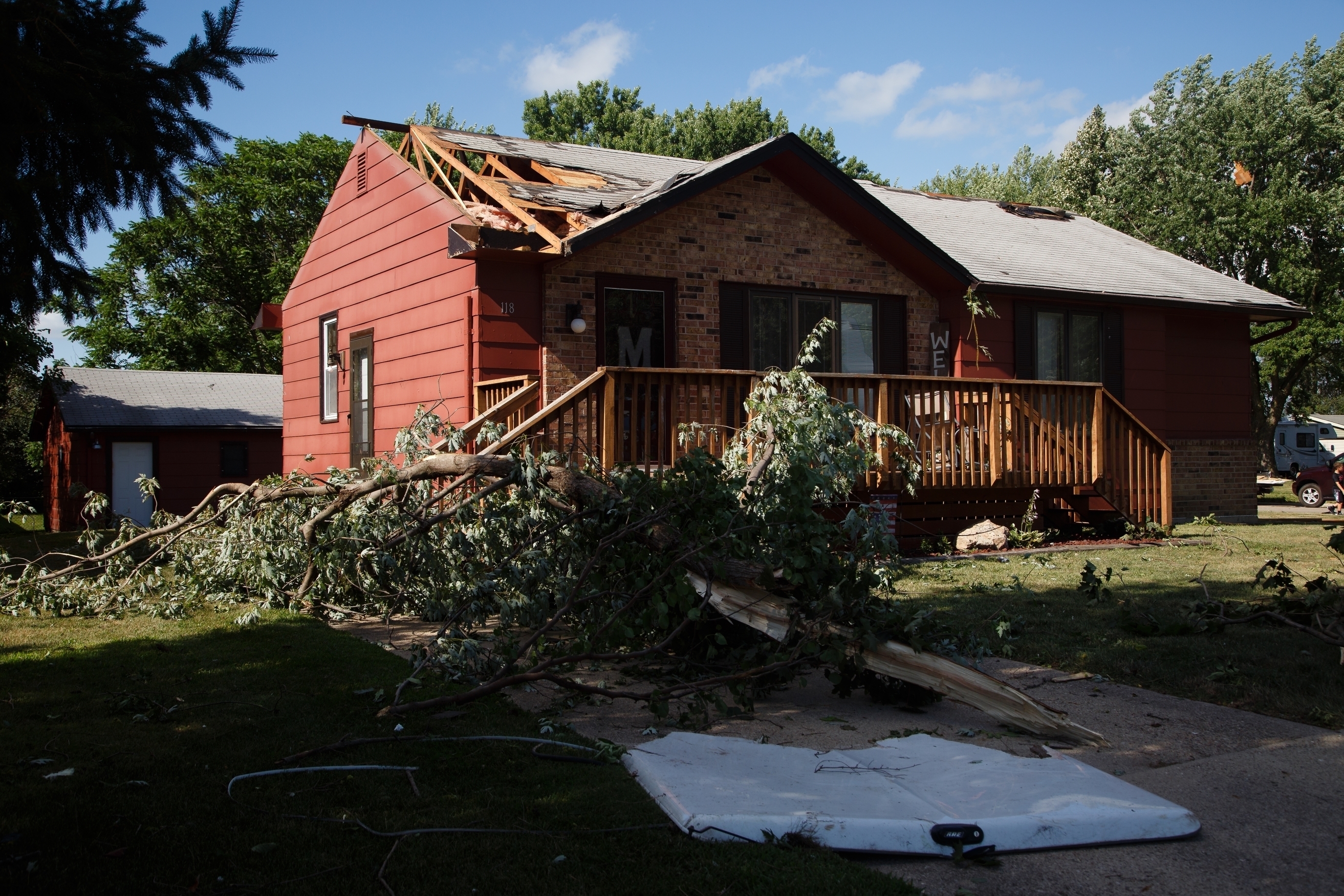 Debris lies on the ground as residents clean up after a tornado swept through Bondurant, Iowa, Thursday, July 19, 2018. A flurry of tornadoes swept through central Iowa Thursday afternoon, flattening buildings and damaging the courthouse in Marshalltown and hitting an agricultural machinery plant in Pella as people were working. (Brian Powers/The Des Moines Register via AP)