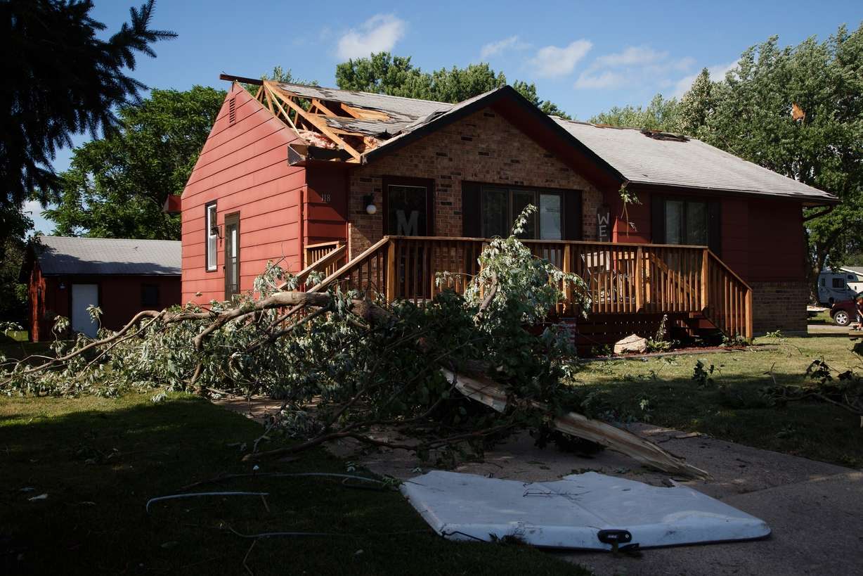 Debris lies on the ground as residents clean up after a tornado swept through Bondurant, Iowa, Thursday, July 19, 2018. A flurry of tornadoes swept through central Iowa Thursday afternoon, flattening buildings and damaging the courthouse in Marshalltown and hitting an agricultural machinery plant in Pella as people were working. (Brian Powers/The Des Moines Register via AP)