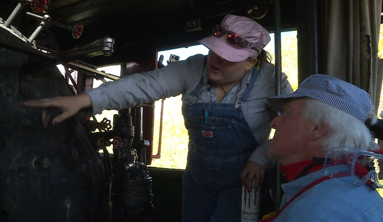 Engineer Angela Stevens discusses the finer points of driving a train to Max Batzer.