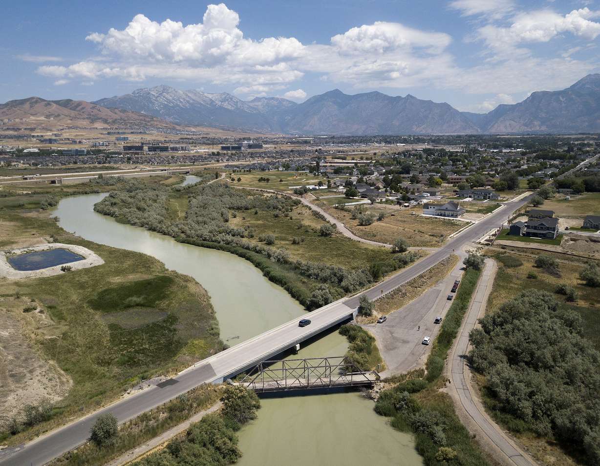 A truck crosses the Jordan River on a bridge next to a century-old bridge in Lehi on Friday, July 13, 2018. City officials are considering demolishing the old bridge after a teenager died jumping from it on July 7. (Photo: James Wooldridge, KSL, File