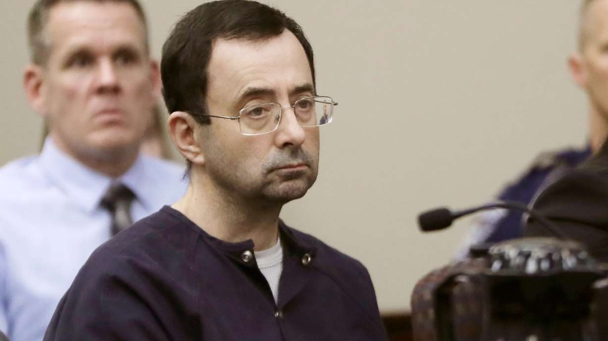 The Latest: Nassar lawyers say he was assaulted in prison