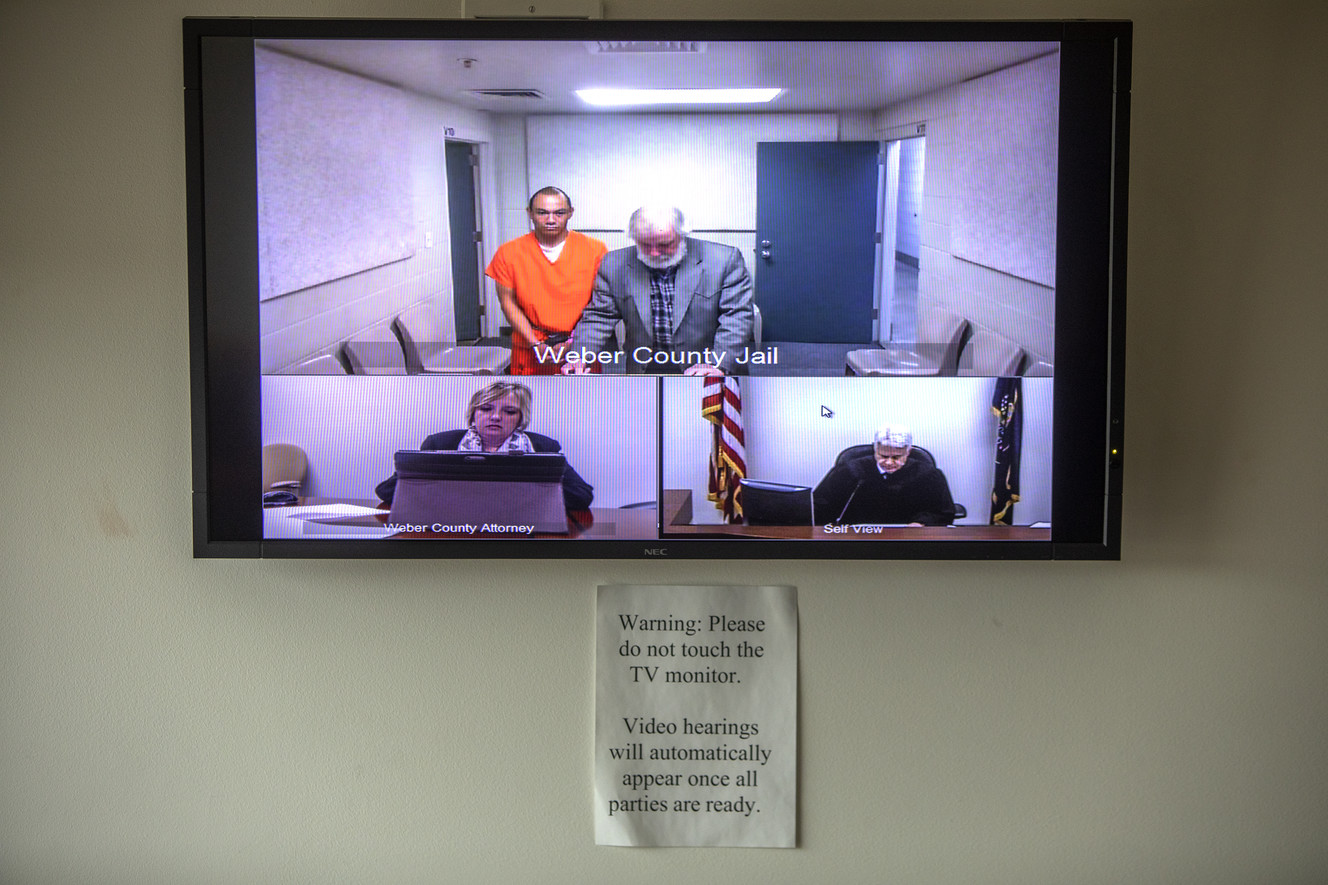 Alex Hidalgo, in orange, appears before a judge via video feed at the Weber County Jail on Wednesday, July 25, 2018. Hidalgo is facing multiple felony charges related to the alleged murder of his 10-month-old son. (Photo: Benjamin Zack)