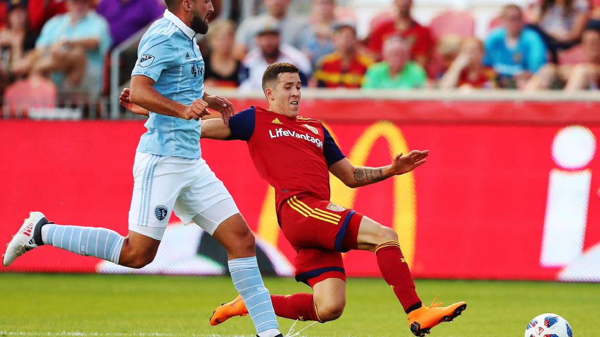 Sporting KC's Emiliano Amor and Real Salt Lake's Aaron Herrera chase down the ball as they play in Open Cup 4th round action at Rio Tinto Stadium in Sandy on Wednesday, June 6, 2018.
