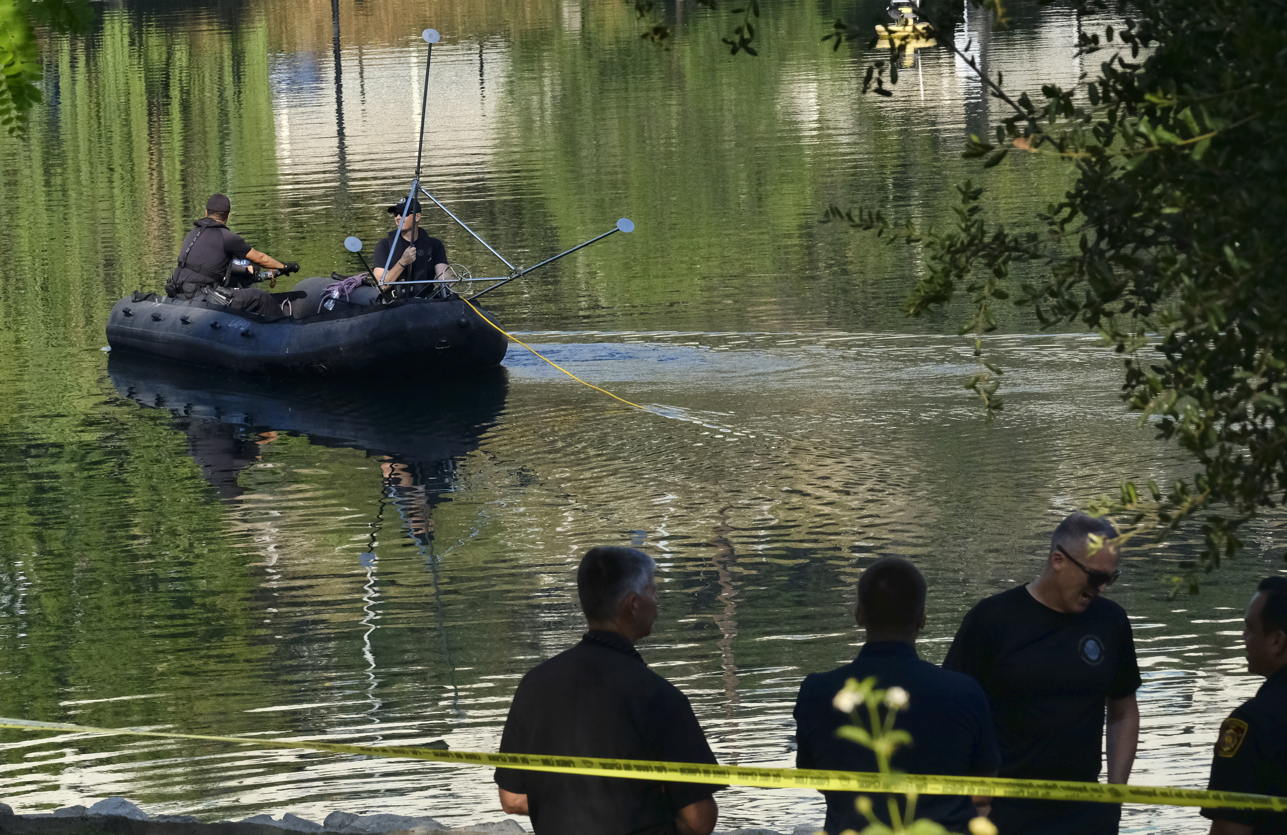 The Latest: Body found in LA lake where paddle boat capsized